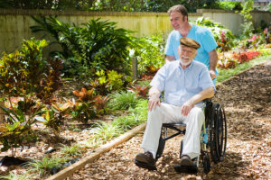 caregiver and elderly man in the garden