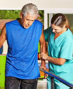 caregiver assisting elderly man